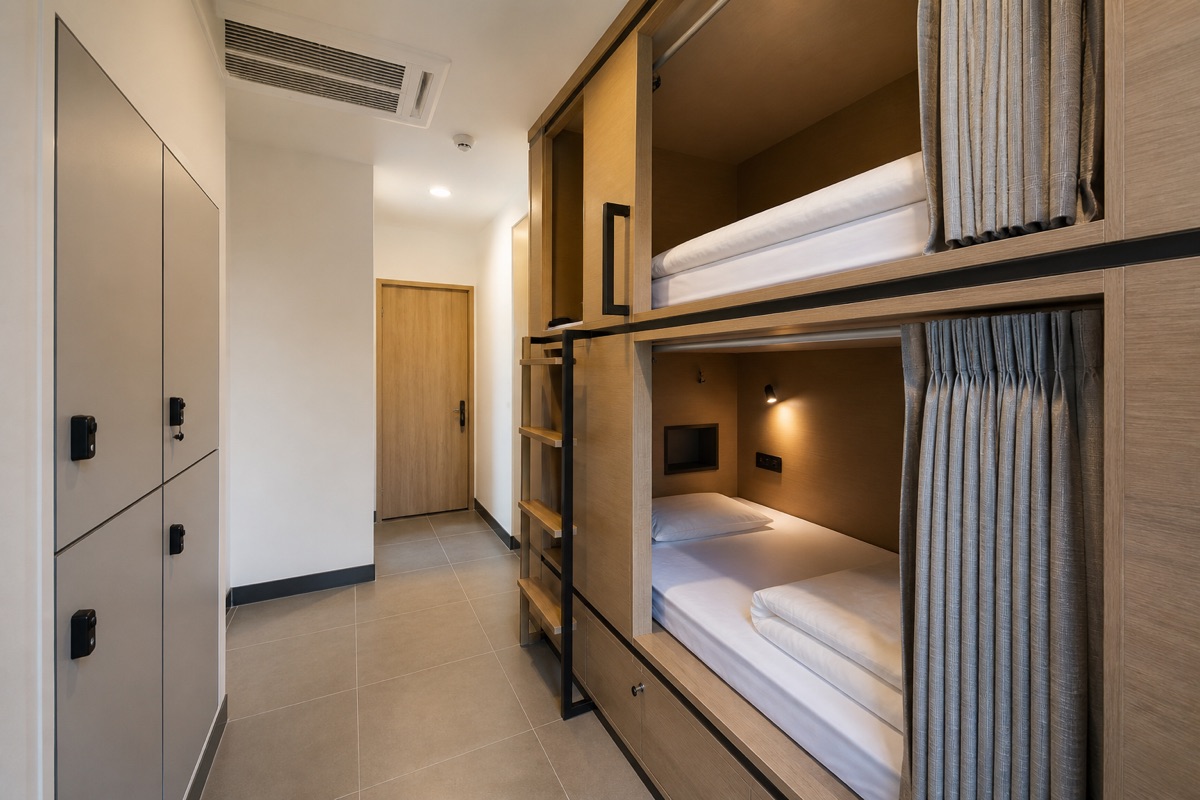 Compact sleeping pods, lockers and a clear corridor in a Korean budget accommodation