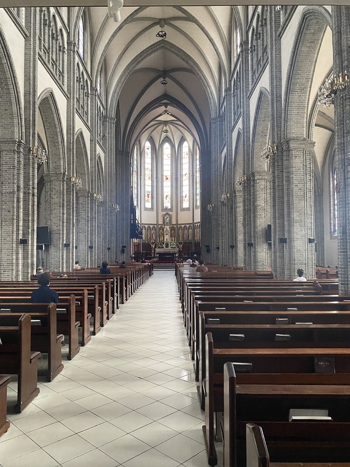 Gothic arches, pews and the central aisle inside Myeongdong Cathedral in Seoul
